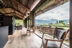 a kitchen and living room with a view of mountains at Chalet Bella in Essert-Romand