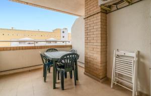 a table and chairs on a balcony with a window at Amazing Apartment In Oropesa Del Mar in Oropesa del Mar