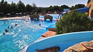 a group of people in a pool at a water park at Casa Los Yayos in Segorbe