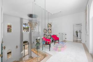 a living room with red chairs and a chandelier at Vale Do Lobo Resort in Vale do Lobo