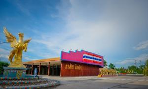 a building with a golden angel statue in front of it at Thansila Resort&Garden Buriram in Buriram