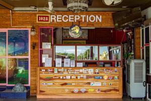 a restaurant with a sign that reads reception at Thansila Resort&Garden Buriram in Buriram