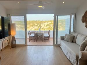a living room with a couch and a table at MiradorEnPorter - Nuevo - Vistas Increibles in Cala'n Porter