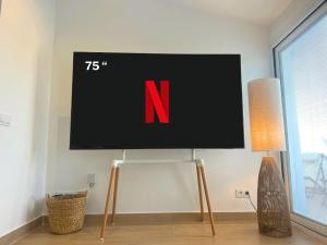 a flat screen tv on a stand in a room at MiradorEnPorter - Nuevo - Vistas Increibles in Cala'n Porter