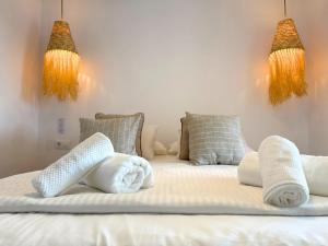 a bedroom with two beds with towels on them at MiradorEnPorter - Nuevo - Vistas Increibles in Cala'n Porter