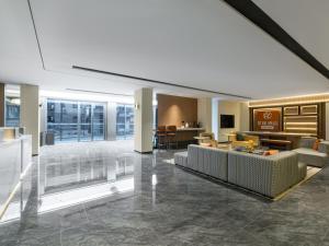 a living room with a couch and a table at Starway Hotel Guilin Two Rivers and Four Lakes Scenic Area in Guilin