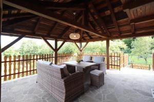 a pavilion with a table and chairs on a patio at Villa Felix with spectacular pool in green oasis in Opatija +17 photos