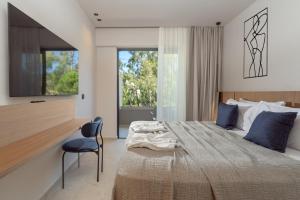 a bedroom with a large bed and a chair at Cabú Hotel - Adults Only in Faliraki +63 photos