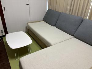 a living room with a couch and a stool at 板橋 RCアネックス Rc308 in Tokyo