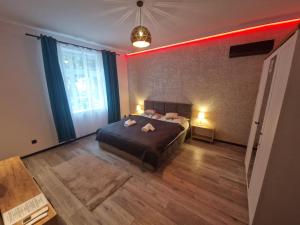 a bedroom with a bed with two towels on it at Apartament Zacisze 1 in Przemyśl