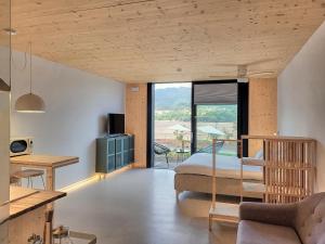 a bedroom with a bed and a living room at Maison Laida in Ibarrangelu