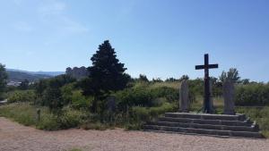a cross on the side of a dirt road at Jasmina in Senj