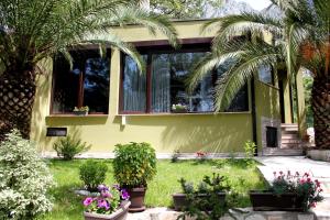 a yellow house with plants in front of it at Meditation in Kotor