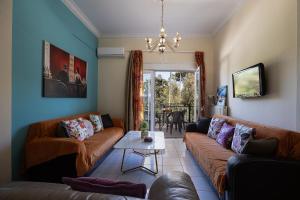 a living room with a couch and a table at Garden Apartment in Rethymno Town