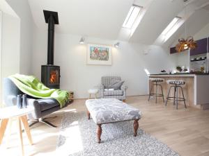 a living room with a couch and a fireplace at 1 Bed in Masham G0089 in Thornton Watlass