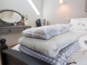 a pile of towels sitting on top of a table at 1 Bed in Masham G0089 in Thornton Watlass +20 photos