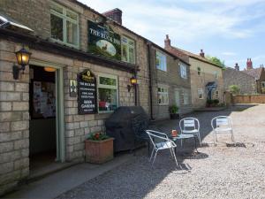 a group of chairs sitting outside of a building at 1 Bed in Masham G0089 in Thornton Watlass