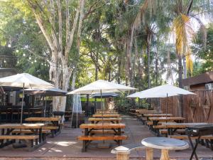 a row of tables and chairs with umbrellas at Eco Lodge Lephalale in Lephalale +18 photos