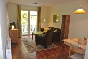 a living room with a couch and a table at Hermannstr 14-Whg 10 in Kühlungsborn +7 photos