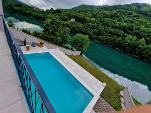 a swimming pool on a balcony with a view of the water at Vila Bilić in Vladići