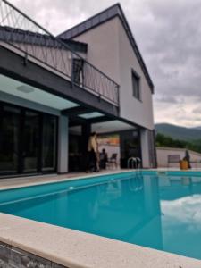 a swimming pool in front of a building at Vila Bilić in Vladići