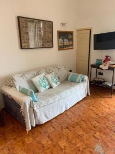 a living room with a white couch with pillows on it at Appartamento proprio sul mare! in Otranto