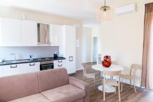 a living room with a couch and a table at Sahil Apartment in Giulianova