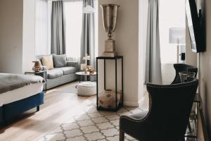 a living room with a bed and a couch at Boutique Hotel Villa Monika in Westerland