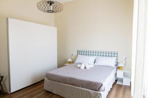 a bedroom with a bed in a white room at Sahil Apartment in Giulianova