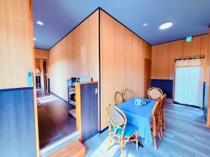 a dining room with a blue table and chairs at Shanshui House TAKASHIMA 一棟貸切 自炊BBQok in Takashima