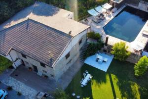 an aerial view of a house with a swimming pool at Acogedora casa en la montaña in La Baronia de Rialb