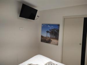a bedroom with a flat screen tv on the wall at Appartement neuf centre historique in Bordeaux