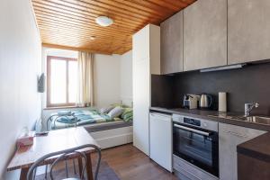 a kitchen with a table and a bed in a room at MiniZell - Small Cosy Central in Mariazell