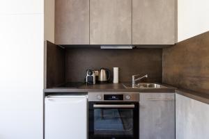 a kitchen with a sink and a stove at MiniZell - Small Cosy Central in Mariazell