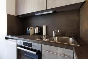 a kitchen with a sink and a stove at MiniZell - Small Cosy Central in Mariazell +10 photos