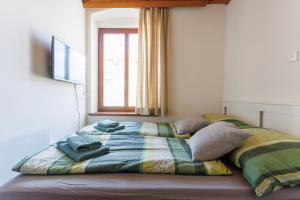 a bed with a blanket and pillows in a bedroom at MiniZell - Small Cosy Central in Mariazell