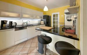 サン・カナにあるLovely Home In St Cannatの白いキャビネットと黒いカウンタートップを備えたキッチン