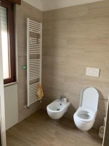 a bathroom with a toilet and a sink at Penthouse in the historic center in Brindisi +35 photos