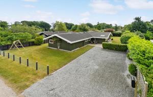 a house with a gravel driveway at 4 Bedroom Awesome Home In Otterup in Otterup