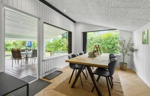 a dining room with a table and chairs at 4 Bedroom Awesome Home In Otterup in Otterup