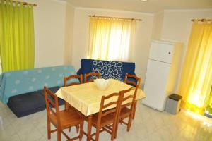 a kitchen with a table and chairs and a couch at Casa Anabela - Beach Apartment in Lourinhã