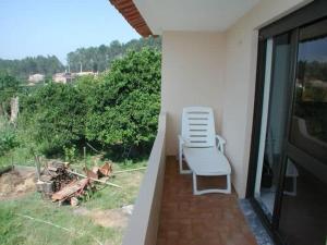 a pair of chairs sitting on a balcony at Casa Caetano in Souto da Carpalhosa