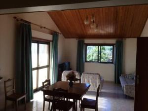 a living room with a table and a couch at Casa Caetano in Souto da Carpalhosa