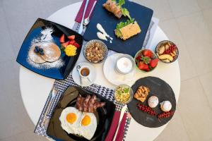 a white table topped with plates of breakfast foods at Hotel Tiffany & Resort in Cesenatico