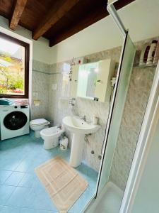 a bathroom with a sink and a toilet and a shower at New Apartment on Ground Floor with Terrace in Desenzano del Garda