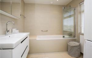 a bathroom with a bath tub and a sink at 'T Sterntje in Bergen aan Zee