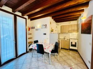 a kitchen and dining room with a table and chairs at New Apartment on Ground Floor with Terrace in Desenzano del Garda