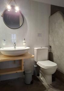a bathroom with a sink and a toilet and a mirror at Paesino in Kionia