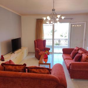 a living room with two couches and a television at Aithrea's HOMES in Pastida Rhodes in Pastida +37 photos