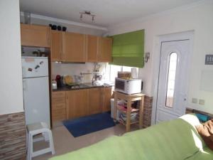 a kitchen with a refrigerator and a stove top oven at Manuel Terrace House in Alvor